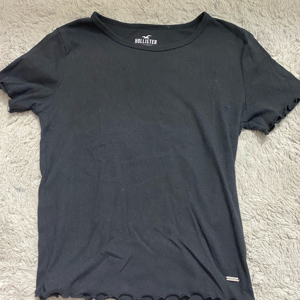 This is a deep navy blue color with a pretty cut on the sleeves and bottem
